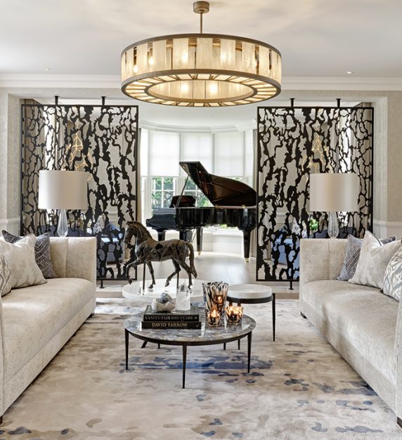 Formal drawing room with large oversized sofas and a beautiful grand piano.